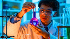 Illustration of a graduate student discovering a shape-recovering liquid that defies thermodynamics.
