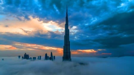 Illustration of the Supernova Tower in Noida enveloped in monsoon clouds, drawing comparisons to Dubai's Burj Khalifa.